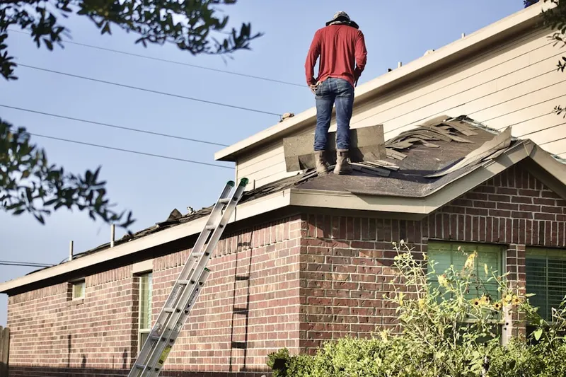 Professional roofer working on a residential roof in Timberleaf